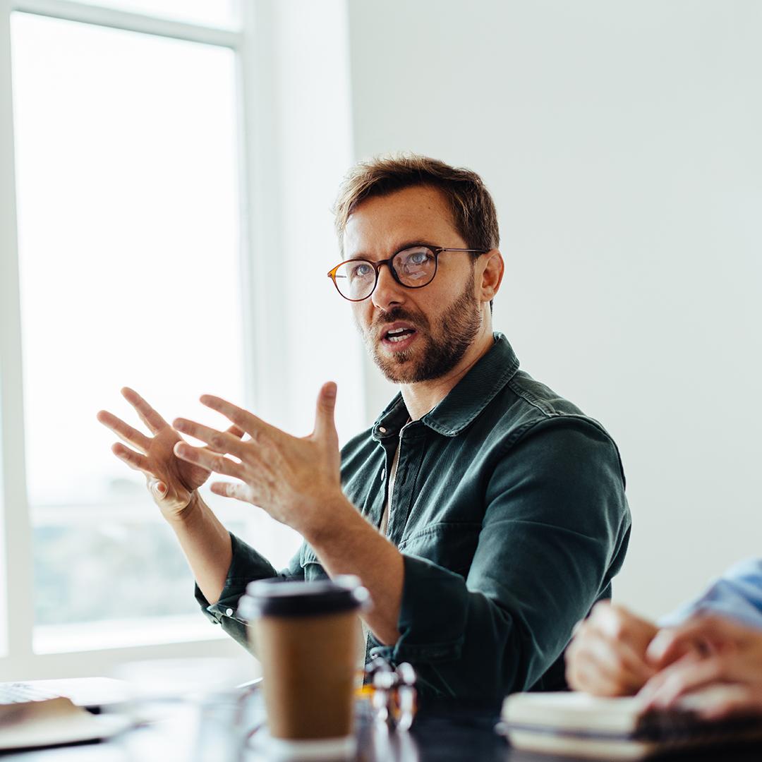 Ein Mann diskutiert mit seinen Kolleginnen